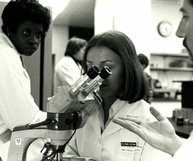 Susan Young Davis and Bonnie J. Piestrak talk with a Microbiolog