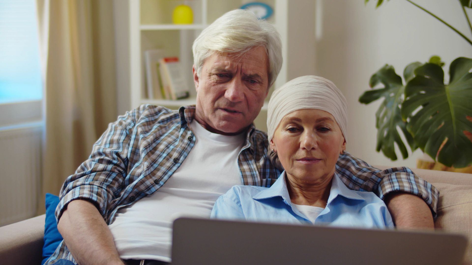 Senior,Husband,And,Wife,With,Cancer,Resting,Together,On,Couch