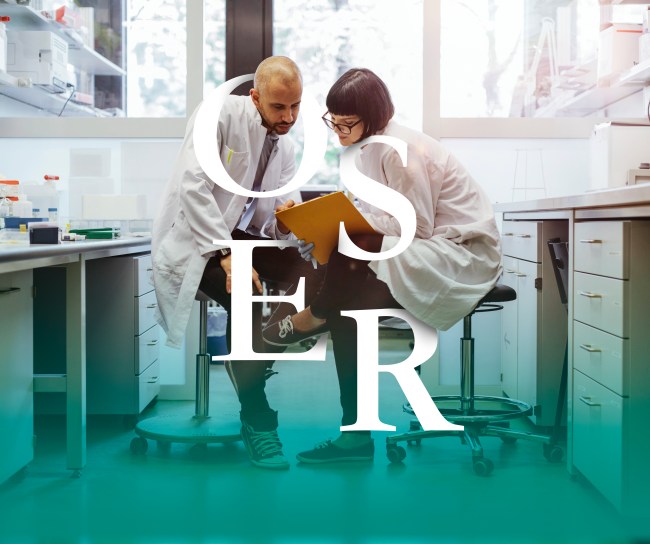 Two scientists inside a laboratory discussing