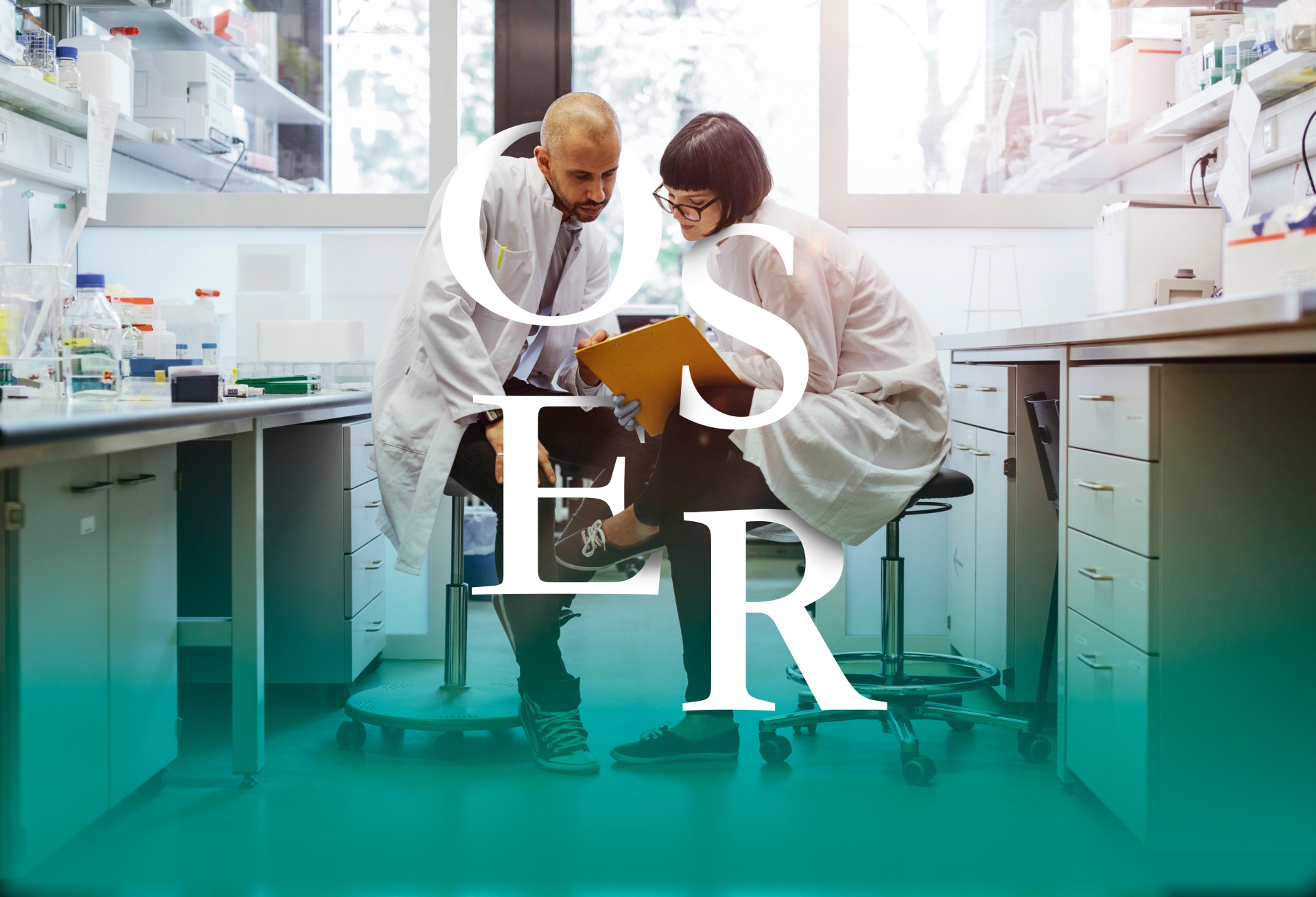 Two scientists inside a laboratory discussing