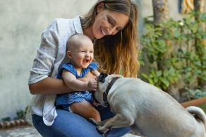 Celebration of life parent baby and dog playing