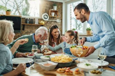 Happy,Multi-generation,Family,Gathering,Around,Dining,Table,And,Having,Fun