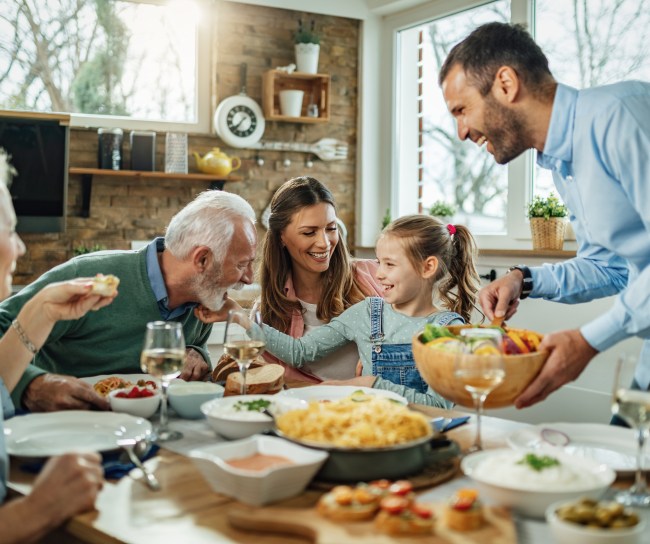 Happy,Multi-generation,Family,Gathering,Around,Dining,Table,And,Having,Fun