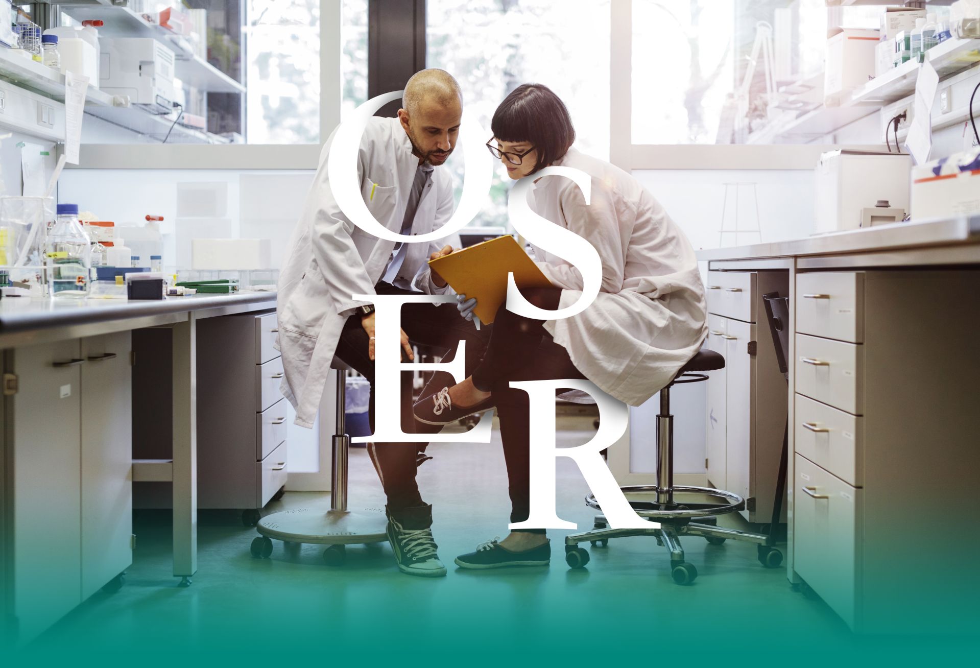 Two scientists inside a laboratory discussing