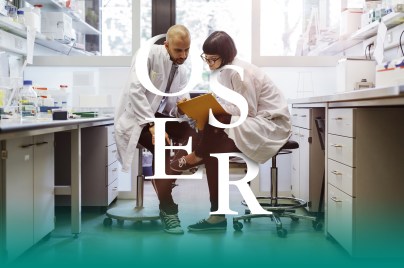 Two scientists inside a laboratory discussing